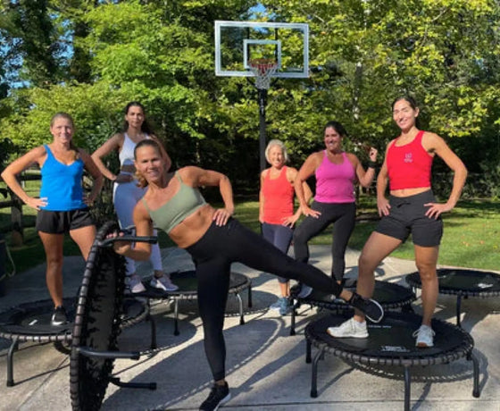 Group of women getting read to do a JumpSport Trampoline Cardio Workout. 