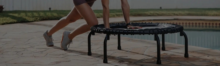 Close-up image of woman stretching on the JumpSport trampoline