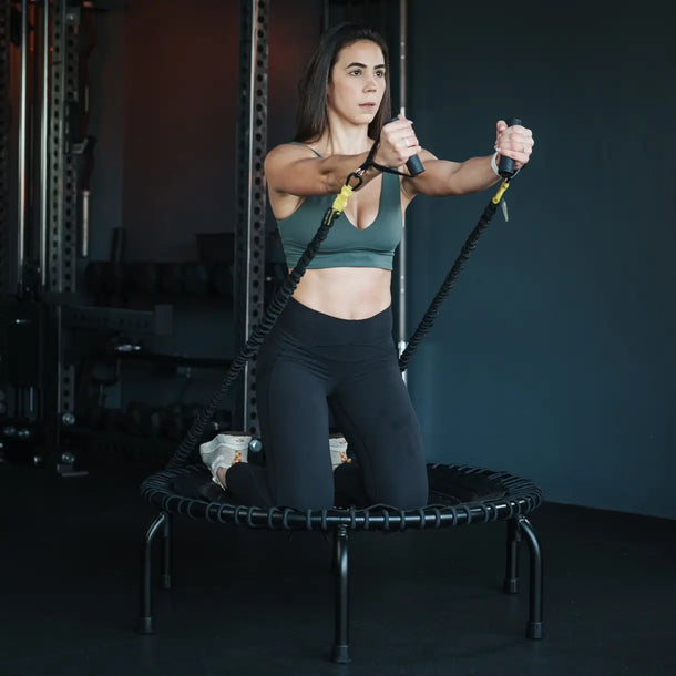 Girl kneeling on the JumpSport 39 inch PREMIUM trampoline