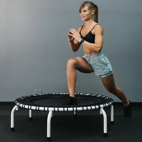 Girl doing lunges on a white JumpSport 44 inch PRO  solid frame with arched legs, model 550 PRO Club Edition