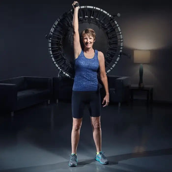 Active aging woman lifting trampoline up into the air