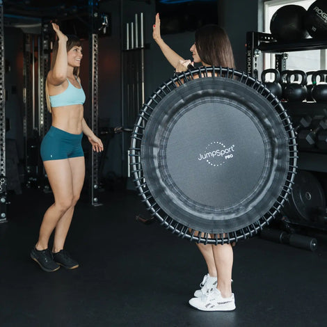 Instructor holding JumpSport Fitness Trampoline high-fiving an instructor