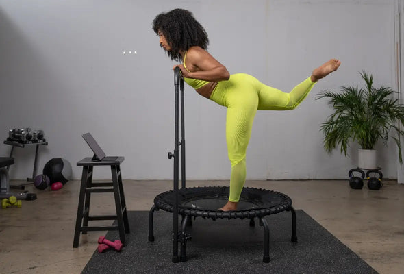 Woman on fitness trampoline watching JumpSport Fitness TV