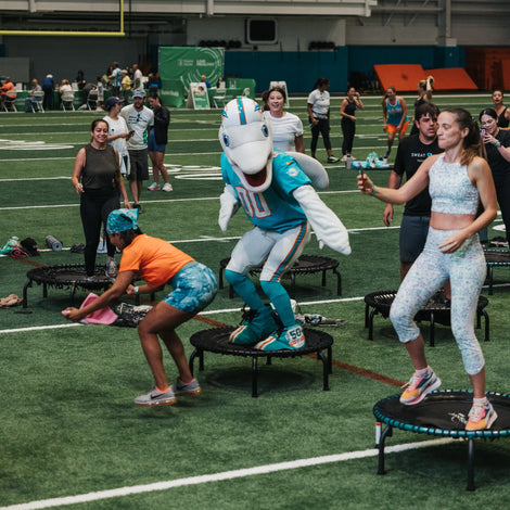 Miami Dolphins Mascot jumping on a trampoline at an event in FL